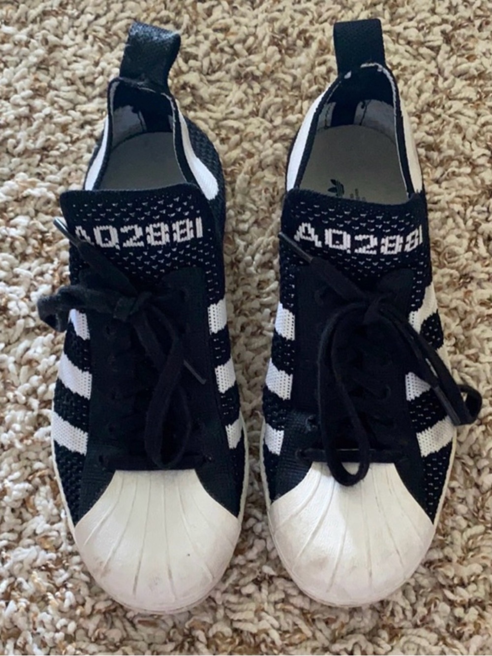 Black and white Adidas Superstar 80s Primeknit sneakers